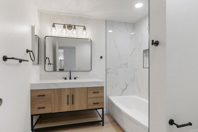 3755 N Vista Campana Unit 30, Oceanside, CA 92057 - full bath with vanity, wood finished floors, and washtub / shower combination