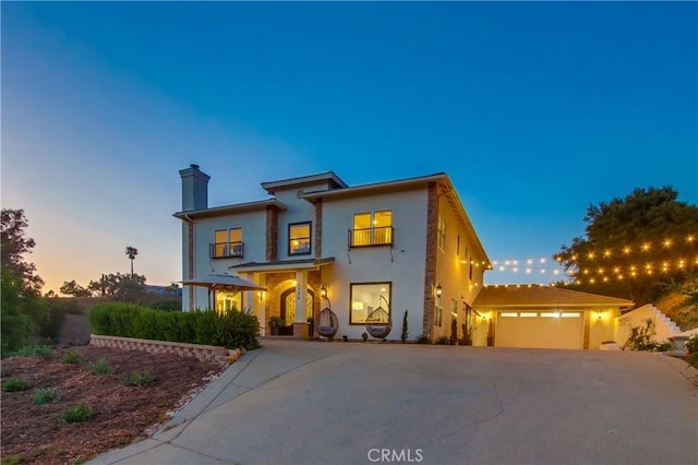 2424 Gird Rd, Fallbrook, CA 92028 - view of front of property with asphalt driveway, an attached garage, stucco siding, and a chimney