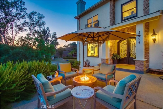 2424 Gird Rd, Fallbrook, CA 92028 - patio terrace at dusk with a patio area and an outdoor living space with a fire pit