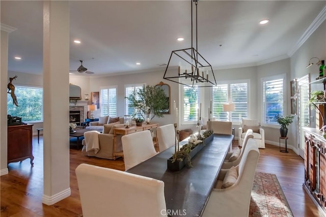 2424 Gird Rd, Fallbrook, CA 92028 - dining room featuring wood finished floors, recessed lighting, ornamental molding, a fireplace, and a chandelier
