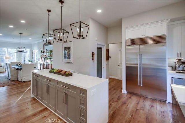 2424 Gird Rd, Fallbrook, CA 92028 - kitchen featuring stainless steel built in fridge, a chandelier, light wood-style flooring, light countertops, and hanging light fixtures