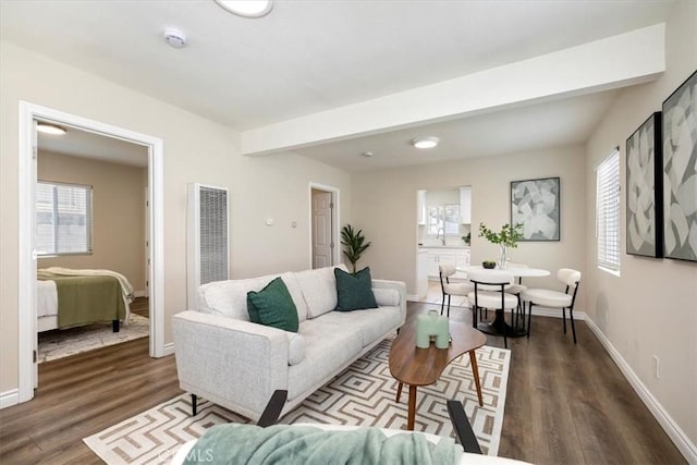 3900 Florence, Bell, CA 90201 - living area featuring a heating unit and wood finished floors