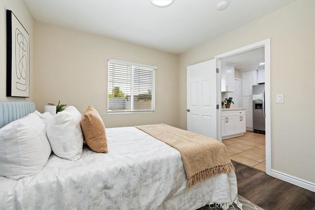 3900 Florence, Bell, CA 90201 - bedroom featuring stainless steel fridge and wood finished floors