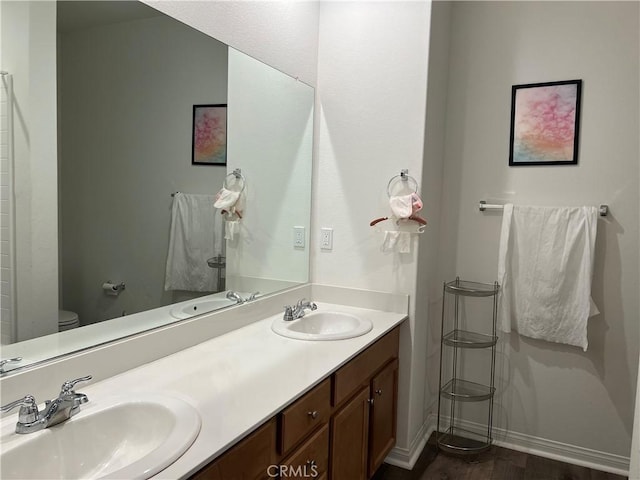 3071 E Silver Sky Dr, Ontario, CA 91762 - full bathroom with double vanity and wood finished floors