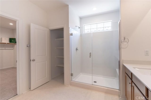 3071 E Silver Sky Dr, Ontario, CA 91762 - bathroom featuring a stall shower, vanity, a walk in closet, and recessed lighting