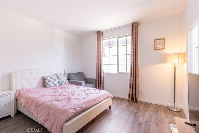 3071 E Silver Sky Dr, Ontario, CA 91762 - bedroom featuring multiple windows and wood finished floors