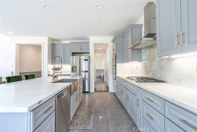 3071 E Silver Sky Dr, Ontario, CA 91762 - kitchen with wall chimney range hood, appliances with stainless steel finishes, light stone counters, tasteful backsplash, and marble look tile flooring
