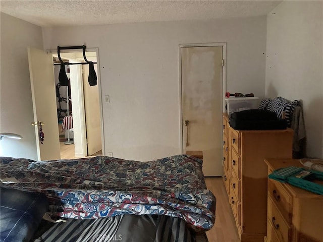 35590 Santa Fe St, Daggett, CA 92327 - bedroom with light wood finished floors and a textured ceiling