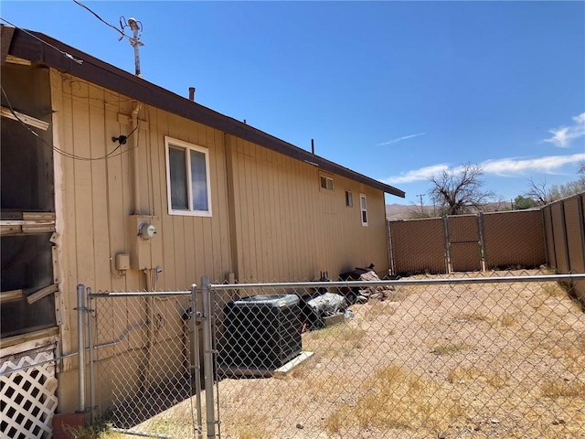 35590 Santa Fe St, Daggett, CA 92327 - view of home's exterior featuring a central air condition unit and a gate