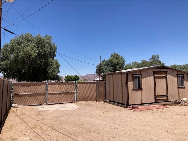 35590 Santa Fe St, Daggett, CA 92327 - view of yard with a gate and an outdoor structure