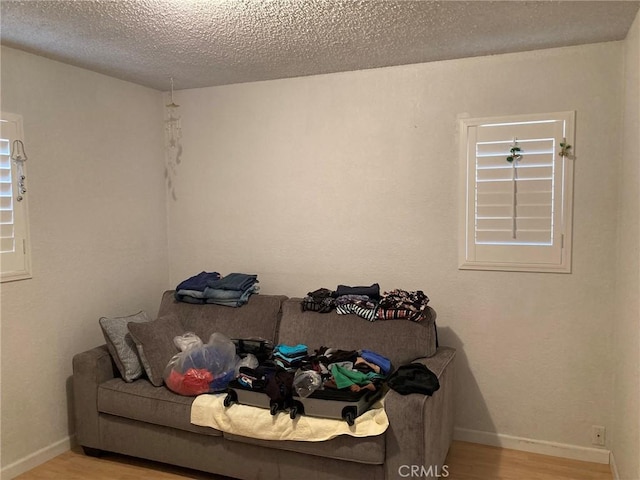 35590 Santa Fe St, Daggett, CA 92327 - unfurnished living room with wood finished floors and a textured ceiling