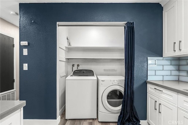 1131 Stewart Ave, Chico, CA 95926 - washroom with washer and clothes dryer, wood finished floors, and a textured wall