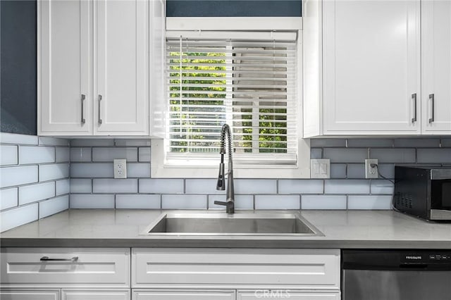 1131 Stewart Ave, Chico, CA 95926 - kitchen with stainless steel dishwasher, white cabinetry, tasteful backsplash, and black microwave