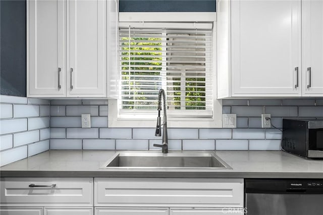 1131 Stewart Ave, Chico, CA 95926 - kitchen featuring stainless steel dishwasher, white cabinets, tasteful backsplash, black microwave, and light countertops