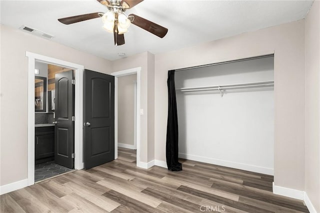 1131 Stewart Ave, Chico, CA 95926 - unfurnished bedroom featuring wood finished floors, a closet, connected bathroom, and ceiling fan