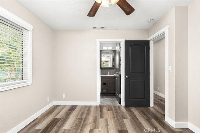1131 Stewart Ave, Chico, CA 95926 - unfurnished bedroom with wood finished floors, connected bathroom, and ceiling fan