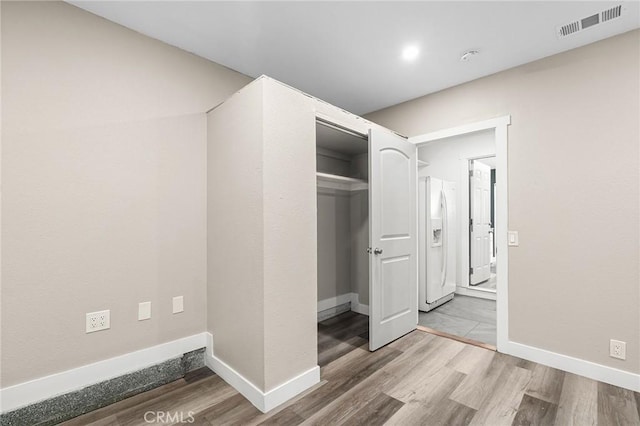 1131 Stewart Ave, Chico, CA 95926 - unfurnished bedroom featuring wood finished floors, white refrigerator with ice dispenser, and a closet