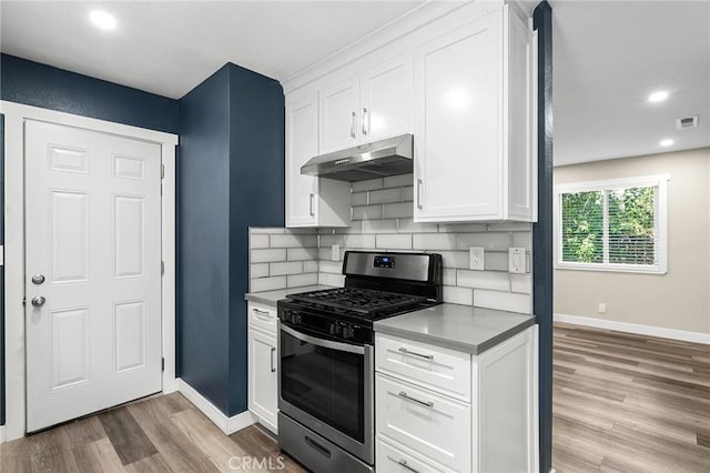1131 Stewart Ave, Chico, CA 95926 - kitchen featuring gas stove, under cabinet range hood, light wood-style floors, white cabinetry, and tasteful backsplash