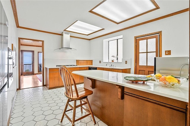 1323 Silvius Ave, San Pedro, CA 90731 - kitchen with wall chimney range hood, gas stovetop, light countertops, brown cabinetry, and crown molding