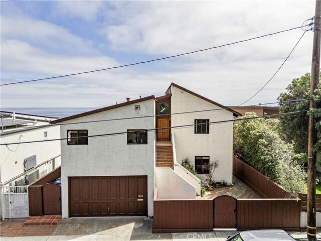 1323 Silvius Ave, San Pedro, CA 90731 - view of front facade featuring a gate, an attached garage, stucco siding, and stairs