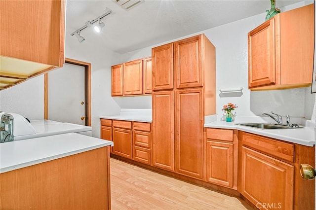 1323 Silvius Ave, San Pedro, CA 90731 - kitchen with washer and clothes dryer, light wood-style flooring, light countertops, and rail lighting