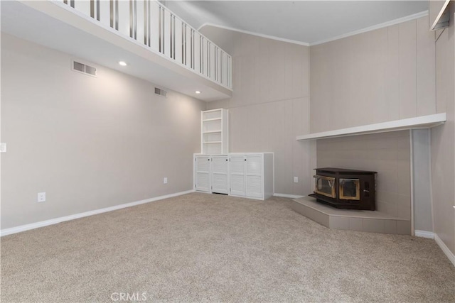 14220 El Monte Rd, Atascadero, CA 93422 - unfurnished living room featuring a wood stove, carpet floors, ornamental molding, and recessed lighting
