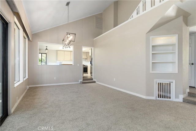 14220 El Monte Rd, Atascadero, CA 93422 - unfurnished living room featuring carpet floors, high vaulted ceiling, built in features, and a chandelier