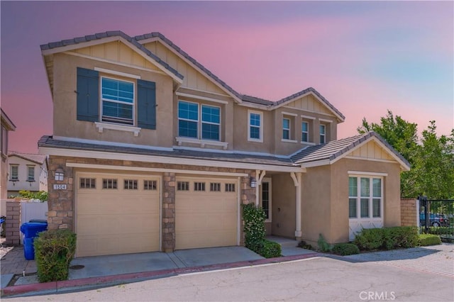 1504 Granada Rd, Upland, CA 91786 - craftsman-style home featuring a garage, stucco siding, concrete driveway, and stone siding
