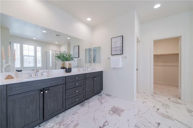 1504 Granada Rd, Upland, CA 91786 - bathroom featuring double vanity, recessed lighting, a walk in closet, a shower with shower door, and marble finish flooring
