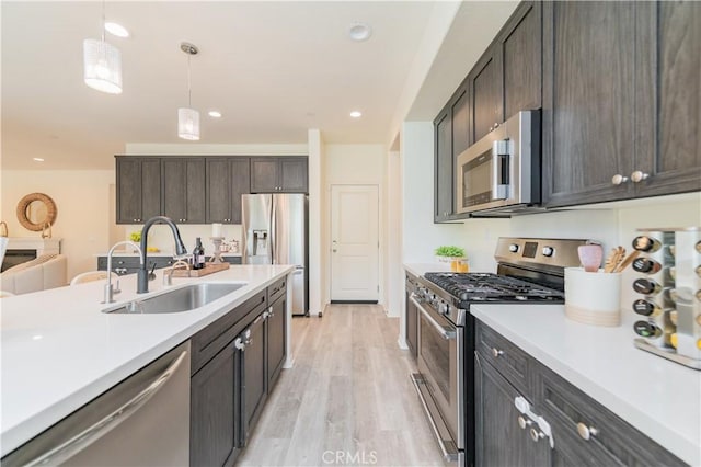 1504 Granada Rd, Upland, CA 91786 - kitchen with stainless steel appliances, light wood-style flooring, light countertops, pendant lighting, and recessed lighting