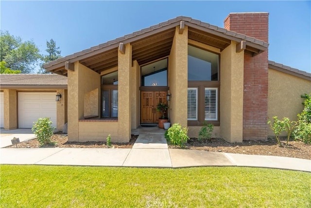 712 Buckingham Dr, Redlands, CA 92374 - view of front of property with stucco siding, a garage, concrete driveway, and a front yard