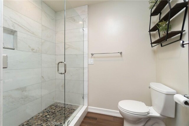 712 Buckingham Dr, Redlands, CA 92374 - bathroom with a stall shower and wood finished floors