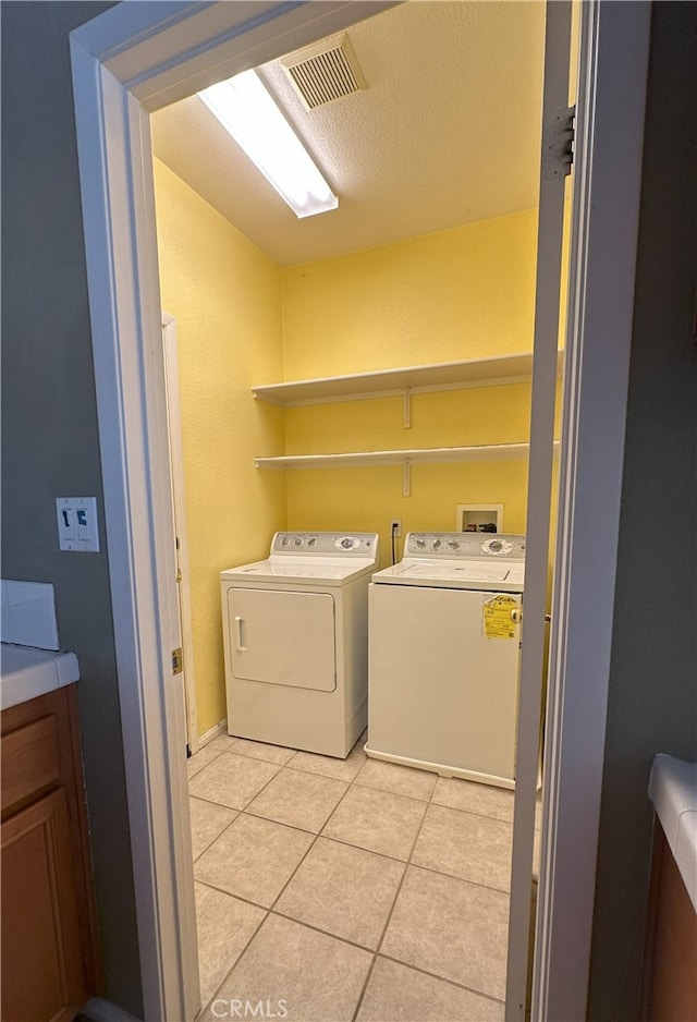1256 Sunburst Dr, Beaumont, CA 92223 - laundry area with washer and clothes dryer and light tile patterned floors