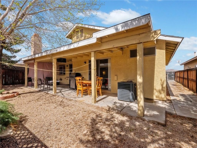 16873 Silica Dr, Victorville, CA 92395 - back of property featuring a patio, stucco siding, and a chimney