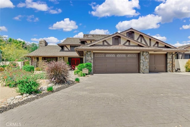 1013 Idaho Ct, Claremont, CA 91711 - english style home with stone siding, a chimney, an attached garage, and decorative driveway