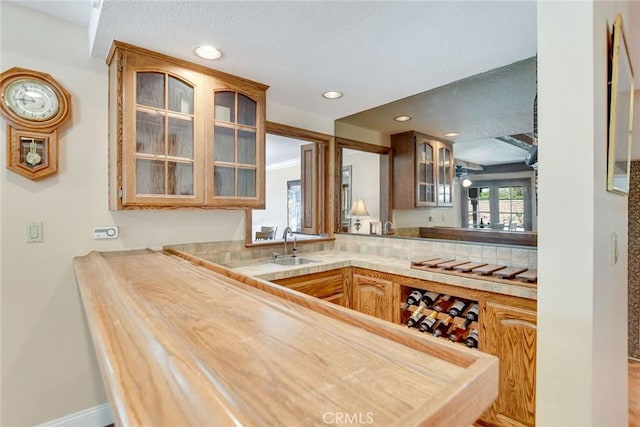 1013 Idaho Ct, Claremont, CA 91711 - kitchen with light countertops, glass insert cabinets, recessed lighting, and a textured ceiling