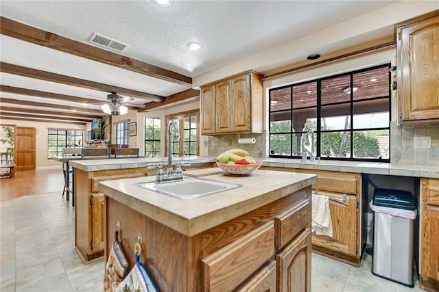 1013 Idaho Ct, Claremont, CA 91711 - kitchen featuring tasteful backsplash, a center island, beam ceiling, healthy amount of natural light, and recessed lighting