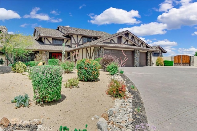 1013 Idaho Ct, Claremont, CA 91711 - english style home featuring a garage, a gate, stucco siding, driveway, and stone siding