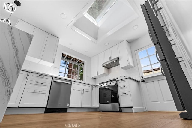 2610 Via Pacheco, Palos Verdes Estates, CA 90274 - kitchen featuring appliances with stainless steel finishes, plenty of natural light, white cabinetry, and decorative backsplash