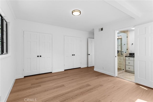 2610 Via Pacheco, Palos Verdes Estates, CA 90274 - unfurnished bedroom featuring two closets, light wood finished floors, ensuite bathroom, and crown molding