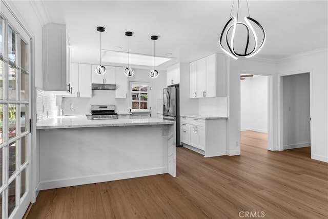 2610 Via Pacheco, Palos Verdes Estates, CA 90274 - kitchen with stainless steel appliances, wood finished floors, a peninsula, white cabinetry, and ornamental molding