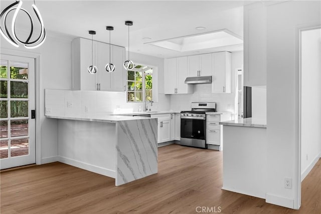 2610 Via Pacheco, Palos Verdes Estates, CA 90274 - kitchen featuring stainless steel gas range, under cabinet range hood, a peninsula, light stone countertops, and white cabinetry