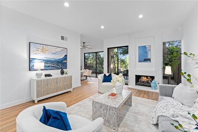 532 Riviera Ct, Fullerton, CA 92835 - living area with wood finished floors, a brick fireplace, and recessed lighting