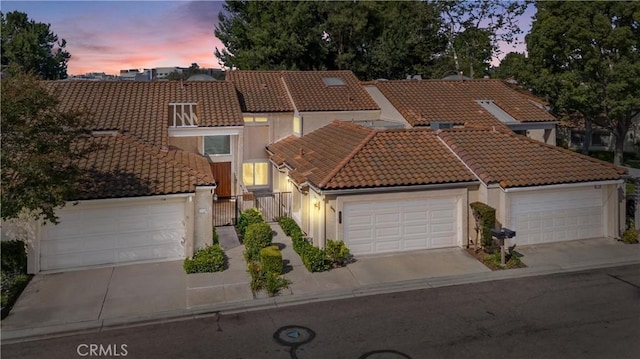 532 Riviera Ct, Fullerton, CA 92835 - mediterranean / spanish-style house with a tile roof, stucco siding, concrete driveway, and a gate