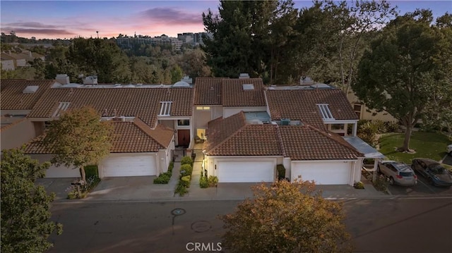 532 Riviera Ct, Fullerton, CA 92835 - view of front of home with a tiled roof, a chimney, stucco siding, and concrete driveway