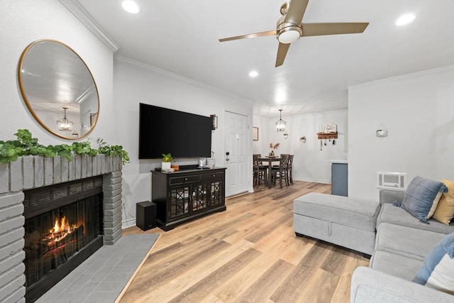 13323 Rancho Penasquitos Blvd Unit D206, San Diego, CA 92129 - living room with ornamental molding, a ceiling fan, recessed lighting, light wood-style flooring, and a brick fireplace
