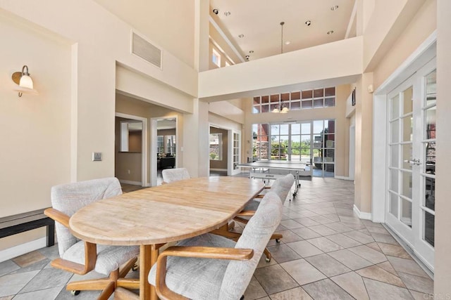 13323 Rancho Penasquitos Blvd Unit D206, San Diego, CA 92129 - dining area featuring a high ceiling, light tile patterned floors, and french doors