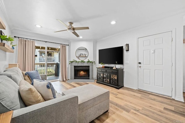 13323 Rancho Penasquitos Blvd Unit D206, San Diego, CA 92129 - living room with crown molding, ceiling fan, light wood finished floors, a fireplace, and recessed lighting