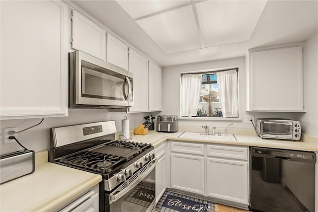 9765 Alburtis Ave Unit 143, Santa Fe Springs, CA 90670 - kitchen featuring stainless steel appliances, white cabinets, and light countertops