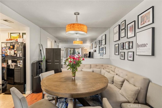 9765 Alburtis Ave Unit 143, Santa Fe Springs, CA 90670 - dining room with light wood-style floors